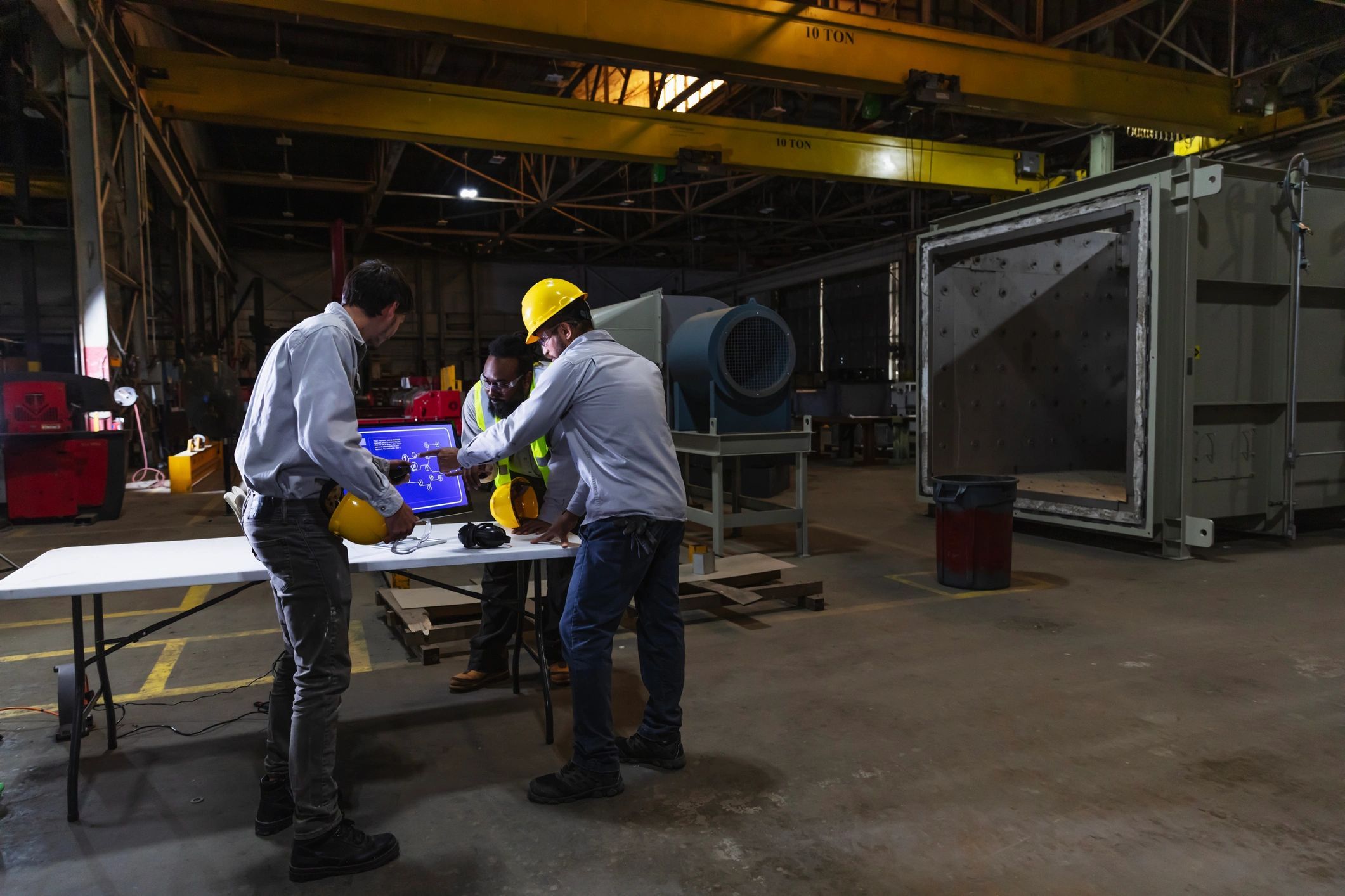 Operations team reviewing planning data in a factory environment